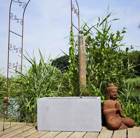 Grey polystone planter trough in garden meditation