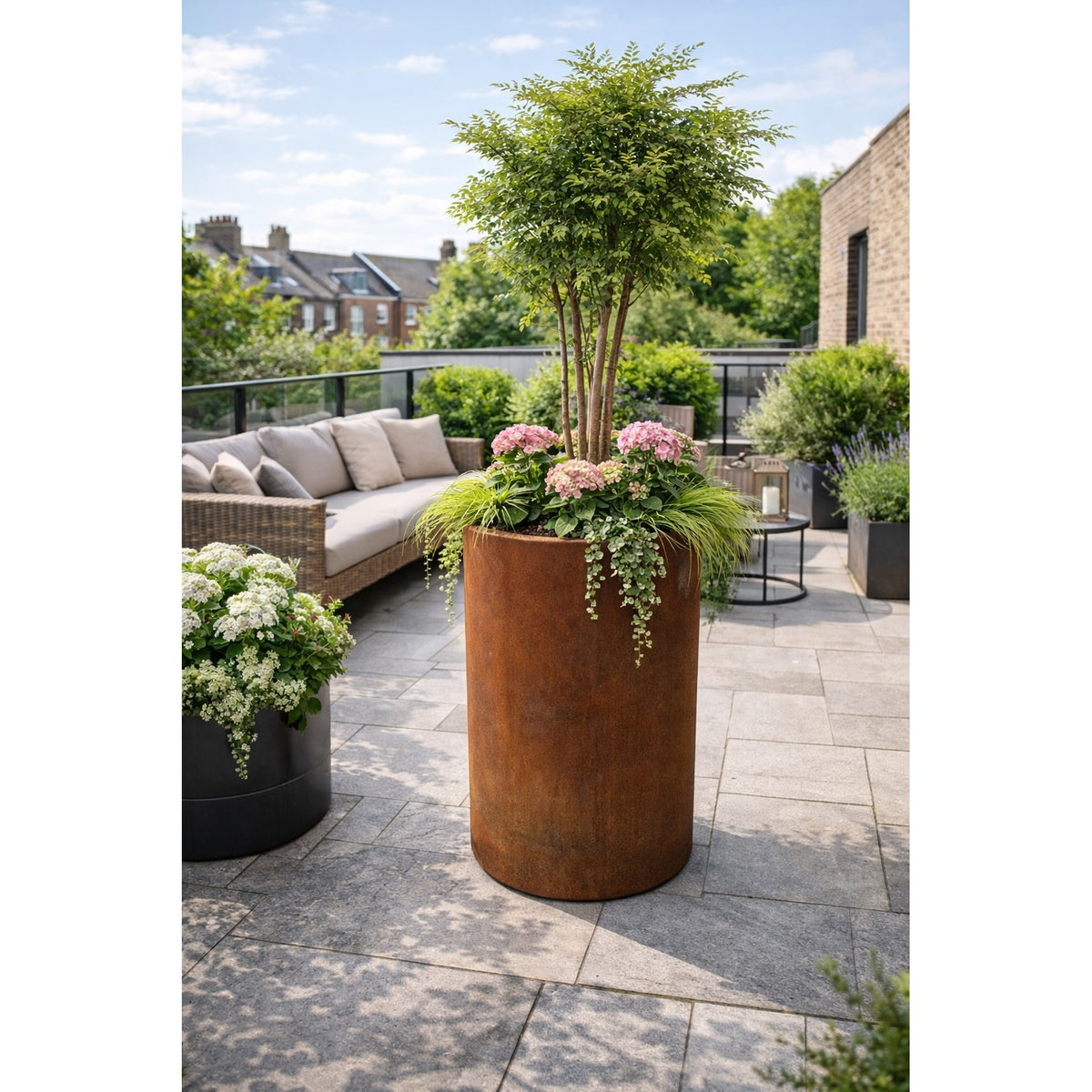 Tall corten steel planter on London roof terrace with contemporary planting, modern urban outdoor design