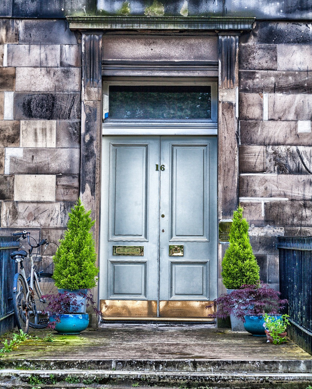 Doorway with Pyramid trees and blie planters