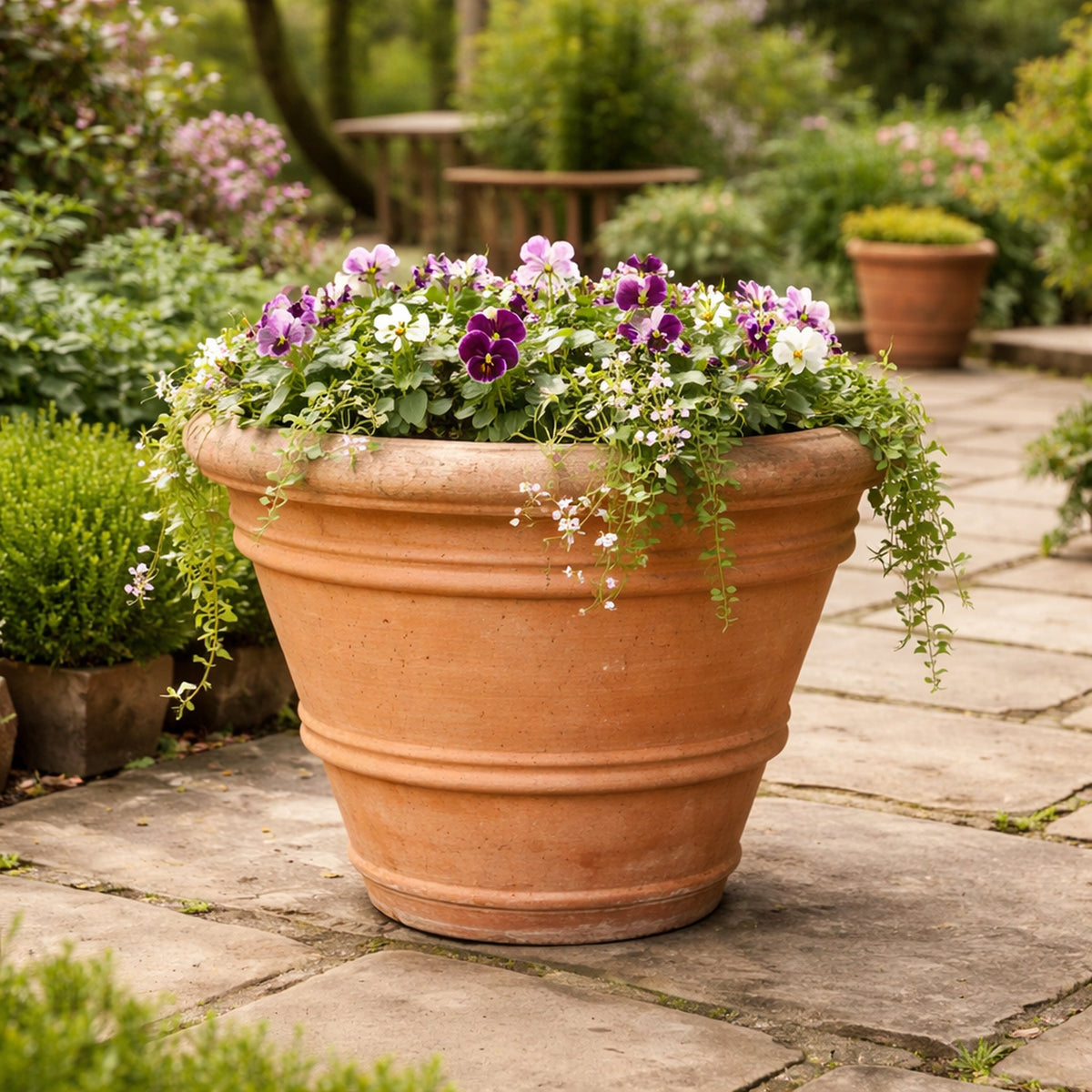 Large handcrafted terracotta garden planter on UK stone terrace outdoor patio pot