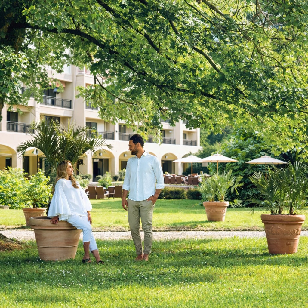 Luxury terracotta planters in landscaped hotel garden courtyard with mature trees and outdoor seating area